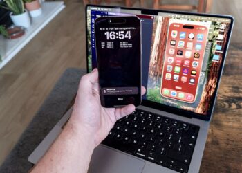 An iPhone 16 Pro Max being mirrored to a MacBook Pro